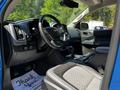 Interior of a 2021 Chevrolet Colorado showing the dashboard steering wheel and front seats with a gear shift and controls visible