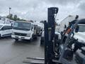 A 2011 Toyota 028FG15 forklift positioned in a parking lot surrounded by other vehicles