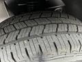 A close-up view of a tire from a 2020 Mercedes-Benz Sprinter showing deep tread patterns and grooves designed for traction and performance