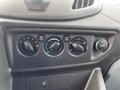The control panel of a 2017 Ford Transit featuring knobs for air conditioning and ventilation settings along with a 12V power outlet