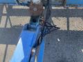 Close-up view of the boom arm and hydraulic system of a 1997 Genie S-65 4X4 with visible rust and cables