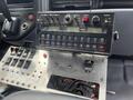 A control panel with various buttons and a digital display from a 2008 Mitsubishi Fuso FE180 truck