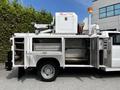 A 2016 Ford F-550 with a utility body and equipment mounted on top including a crane and storage compartments on the side
