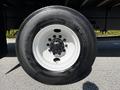 Close-up of a Hino 338 truck tire featuring a shiny white rim black rubber tread and visible wheel bolts