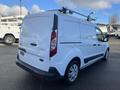 A white 2017 Ford Transit Connect van with a ladder rack on top parked at a lot