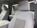 Interior view of a 2015 Ford F-250 SD showing gray cloth seats with a fabric pattern and headrests in a spacious cabin