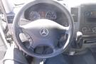 View of the steering wheel and dashboard of a 2012 Mercedes-Benz Sprinter showing the speedometer and controls on the wheel