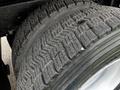 Close-up of a tire from a 2008 International 7500 showing a deep tread pattern with visible wear and rubber texture