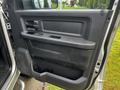 Interior view of a 2012 RAM 3500 door panel featuring control buttons and a storage compartment