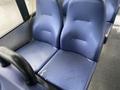 Two blue upholstered seats in a vehicle interior with textured fabric and visible water marks