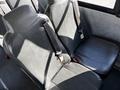 The image shows the interior seating of a 2022 Blue Bird Vision school bus with black vinyl seats and seat belts