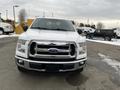 A white 2017 Ford F-150 is parked with a prominent chrome grille and a bold front design