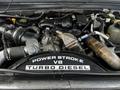 A 2009 Ford F-550 engine with a Power Stroke V8 Turbo Diesel label visible among various engine components and hoses