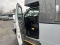 A 2017 Chevrolet Express with an open driver's door revealing the interior and steering wheel