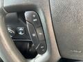 Steering wheel controls of a 2018 Chevrolet Express featuring buttons for adjusting settings and functions like cruise control