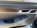 The interior door panel of a 2017 Genesis G80 featuring a handle speaker grille and a window control button