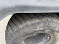 Close-up of a rugged tire from a 2011 Kubota RTV 1140 CPX showcasing deep tread patterns designed for off-road terrain