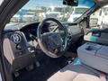 Interior view of a 2014 Ford F-150 showing the steering wheel dashboard and seating area