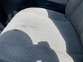 A gray fabric seat with a visible stain in a 2009 Chevrolet Express