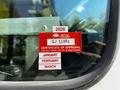 A red and white certificate of approval sticker affixed to a window displaying the year 2026 and months January February March with a reference number GJ 11951