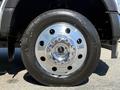 Close-up of a chrome wheel rim and tire from a 2024 Ford F-550 Super Duty showcasing multiple lug nuts and the tire brand Continental