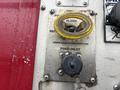 A metallic control panel featuring a yellow foam inlet valve and various labeled instructions for flushing and draining lines