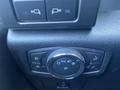 Close-up of the control panel inside a 2016 Ford F-150 featuring buttons for light settings and a dial for adjusting brightness