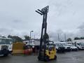 A yellow 2010 Hyster S80XLBCS forklift with extended forks lifted high, showcasing its capability for handling heavy loads
