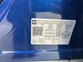 A blue 2022 Chevrolet Equinox with a vehicle information label showing specifications and manufacturing details