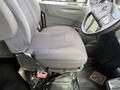 A driver's seat from a 2011 International 4300 featuring gray fabric upholstery and adjustable controls on the side