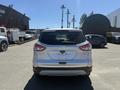 A white 2014 Ford Escape viewed from the rear showing the back tailgate and bumper without any markings or license plate
