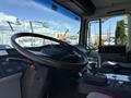 Interior view of a 1994 Volvo FE 42 showcasing the steering wheel dashboard controls and gear shift in the foreground