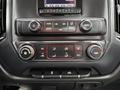 The dashboard controls of a 2015 GMC Sierra 1500 featuring climate control buttons and a touchscreen display
