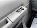 Interior door controls of a 2013 Ford Econoline showing window control buttons in a light grey panel