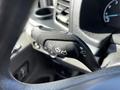 A close-up of the turn signal lever inside a 2022 Ford Transit showing controls for turn signals and headlights