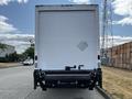 A white 2006 Hino 268 box truck viewed from the rear with a loading dock and diamond plate on the back surface