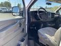 Interior of a 2012 GMC Savana showing the dashboard steering wheel driver seat and control panel