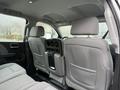 Interior view of a 2015 GMC Sierra 1500 showing two rear seats with headrests and a center console with cup holders