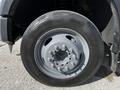 Close-up of a 2008 Ford F-550 tire showcasing a gray rim with multiple bolts and a heavy-duty tread pattern