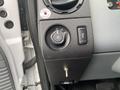 Close-up of the control panel in a 2015 Ford F-250 SD featuring switch for headlights and brake settings