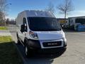 A white 2021 RAM Promaster van parked with a sleek front design and prominent RAM logo on the grille