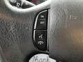 Close-up of the steering wheel controls of a 2014 Ford Econoline featuring buttons for on off settings and phone functions