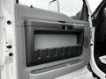 A close-up of the door panel of a 2022 Ford F-750 showing a gray and black design with a large storage compartment and a handle