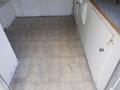 Interior view of a 2004 Royal 18 Foot Office Trailer with a tiled floor and cabinet doors visible along the walls
