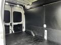 Interior view of a 2020 Ford Transit cargo van featuring a spacious and empty rear cargo area with a flat floor and side walls lined with a dark material