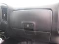 Interior view of a 2015 Chevrolet Silverado 1500 dashboard showing a black glove compartment with a button to open it