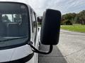 A 2004 Toyota Toyoace with a large side mirror and a white exterior parked at an angle