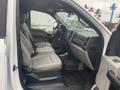 Interior view of a 2021 Ford F-550 with two leather seats a dashboard and floor mats displayed in a truck cabin