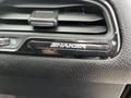 Close-up of the air vent in a 2017 Dodge Challenger featuring the SHAKER badge