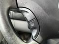 Close-up of a steering wheel control panel featuring buttons for cruise control and audio settings on a 2012 Mercedes-Benz Sprinter